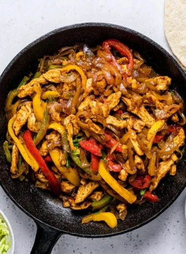 Delicious Chicken Fajitas with peppers and onions served on a plate.
