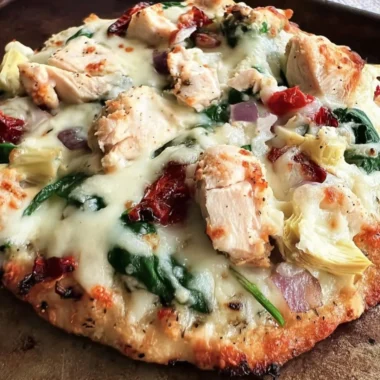 Delicious Chicken Spinach Artichoke Pizza topped with fresh ingredients