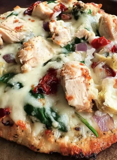 Delicious Chicken Spinach Artichoke Pizza topped with fresh ingredients