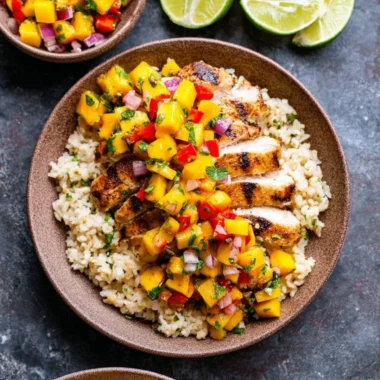 Chipotle lime grilled chicken served with vibrant mango salsa on a wooden platter