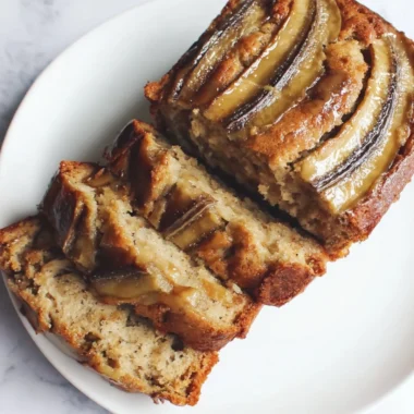 Loaf of classic banana bread sweetened with honey on a wooden cutting board
