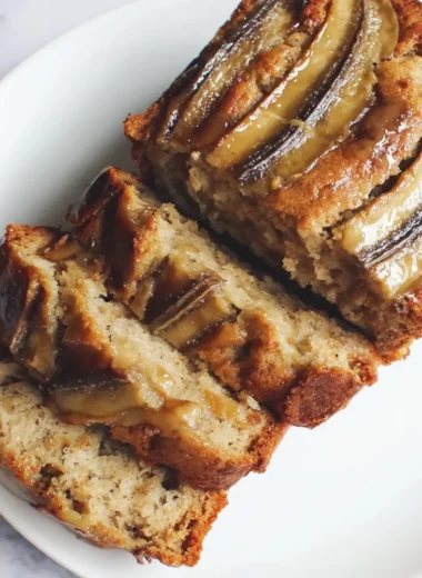 Loaf of classic banana bread sweetened with honey on a wooden cutting board
