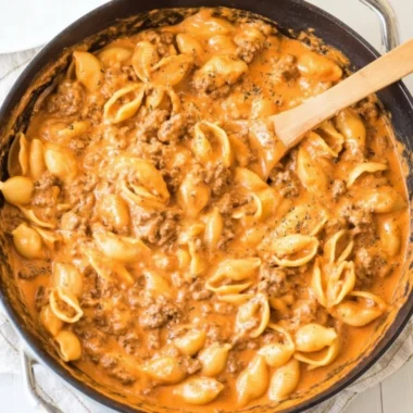 Creamy beef and shells served in a bowl, garnished with parsley.