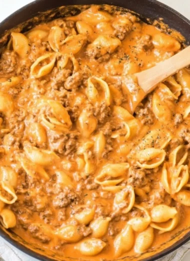 Creamy beef and shells served in a bowl, garnished with parsley.