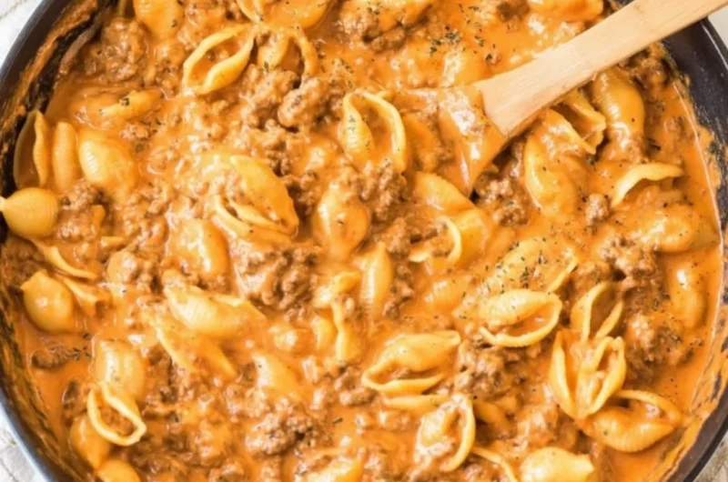 Creamy beef and shells served in a bowl, garnished with parsley.