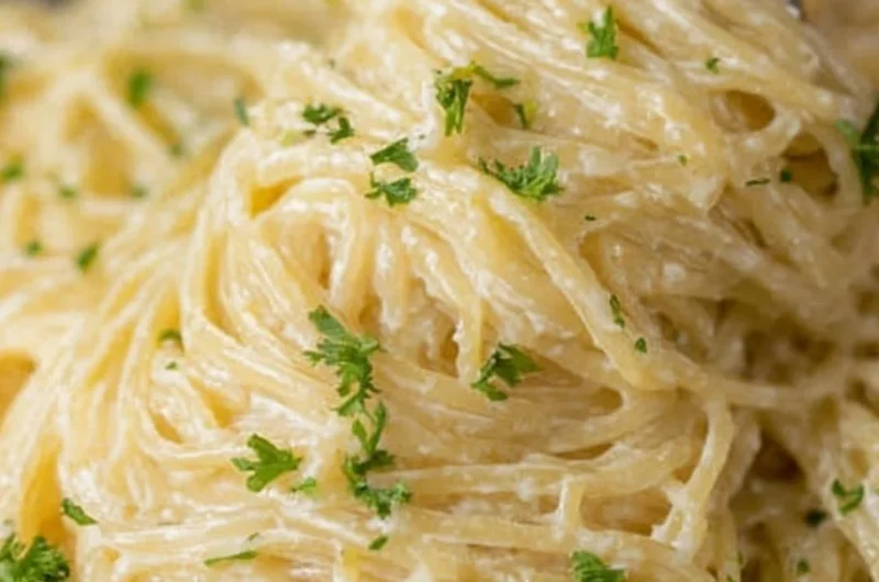 Bowl of creamy garlic parmesan pasta garnished with parsley