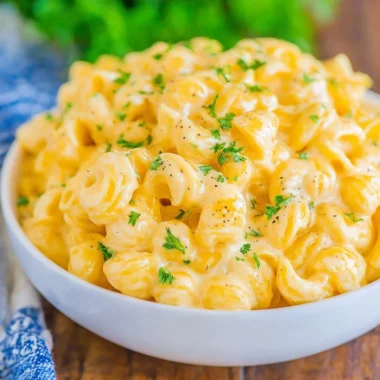 Creamy mac and cheese dish topped with golden breadcrumbs