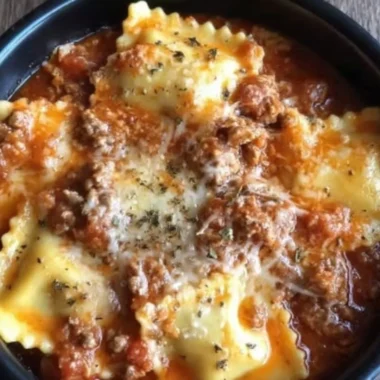 A delicious serving of Crockpot Ravioli Lasagna with melted cheese and rich sauce.