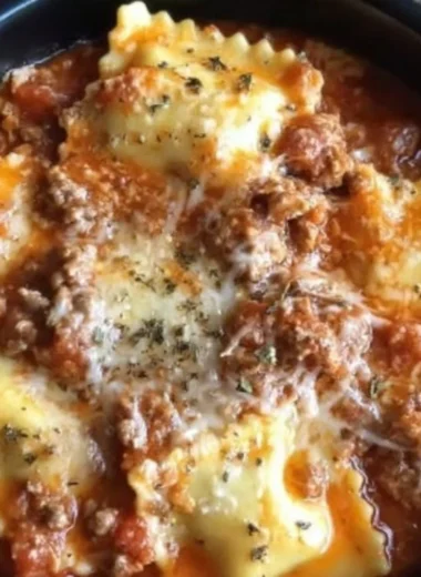 A delicious serving of Crockpot Ravioli Lasagna with melted cheese and rich sauce.