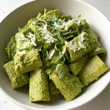 Plate of Green Goddess Pesto Pasta topped with fresh basil and pine nuts