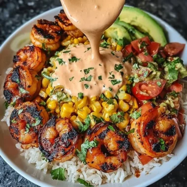 Delicious Grilled Shrimp Bowl with avocado, corn salsa, and creamy sauce.