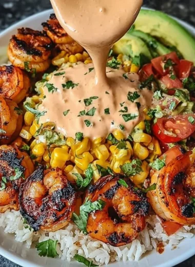Delicious Grilled Shrimp Bowl with avocado, corn salsa, and creamy sauce.