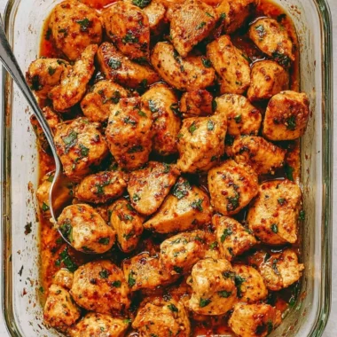 Delicious and juicy oven baked chicken bites on a rustic wooden board