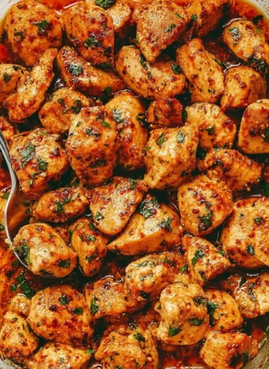 Delicious and juicy oven baked chicken bites on a rustic wooden board