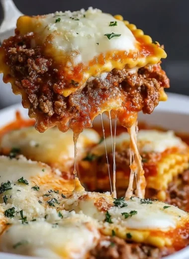 Delicious Million Dollar Ravioli Casserole topped with cheese and herbs.