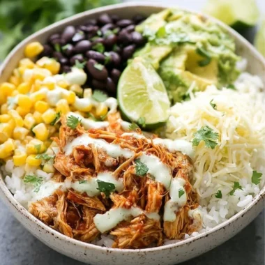 Slow Cooker Chicken Burrito Bowl with rice, beans, and fresh toppings