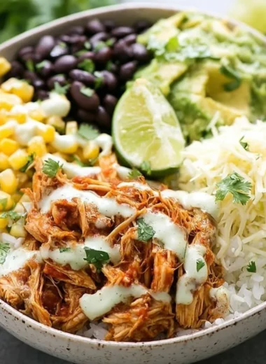 Slow Cooker Chicken Burrito Bowl with rice, beans, and fresh toppings