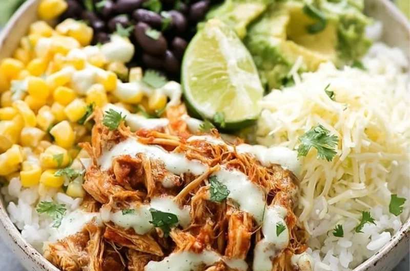 Slow Cooker Chicken Burrito Bowl with rice, beans, and fresh toppings