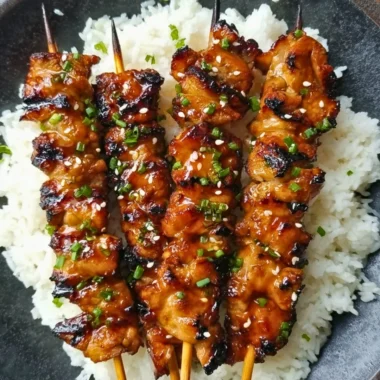 Grilled teriyaki chicken skewers served on a plate