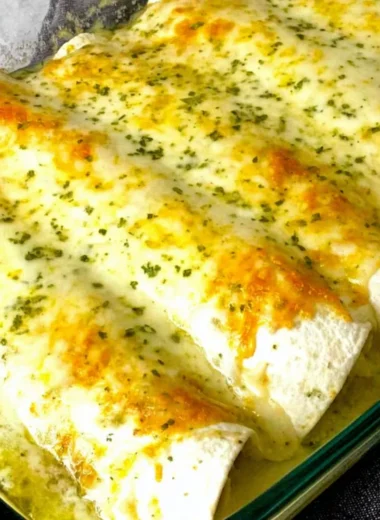Delicious white chicken enchiladas topped with creamy sauce