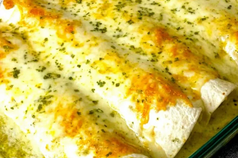 Delicious white chicken enchiladas topped with creamy sauce