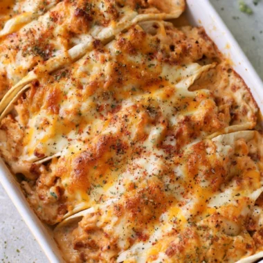 Baked chicken bacon ranch tacos topped with cheese and herbs