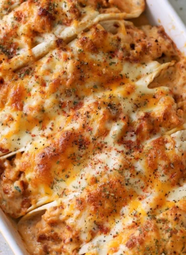 Baked chicken bacon ranch tacos topped with cheese and herbs