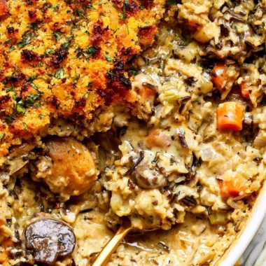 Creamy chicken wild rice casserole served in a baking dish
