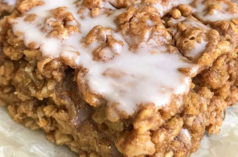 Bowl of healthy cinnamon roll baked oatmeal topped with cinnamon and nuts