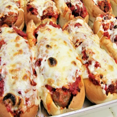 Oven baked meatball sandwiches served on crusty bread with melted cheese