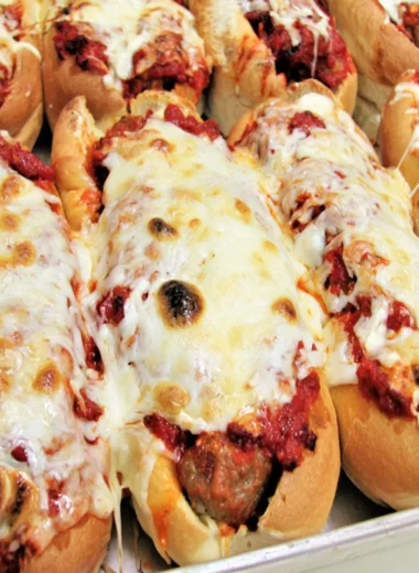 Oven baked meatball sandwiches served on crusty bread with melted cheese